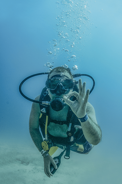 Scuba diver giving underwater okay hand signal