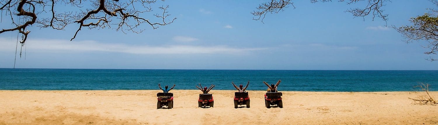 ATV adventures in Riviera Nayarit Mexico - 4 people on the beach with ATVs