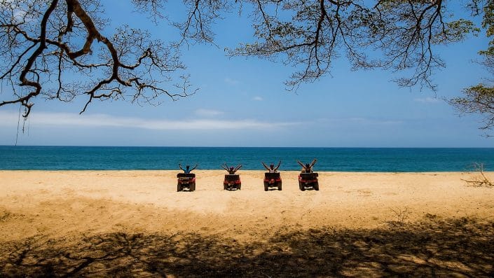 ATV adventures in Riviera Nayarit Mexico - 4 people on the beach with ATVs