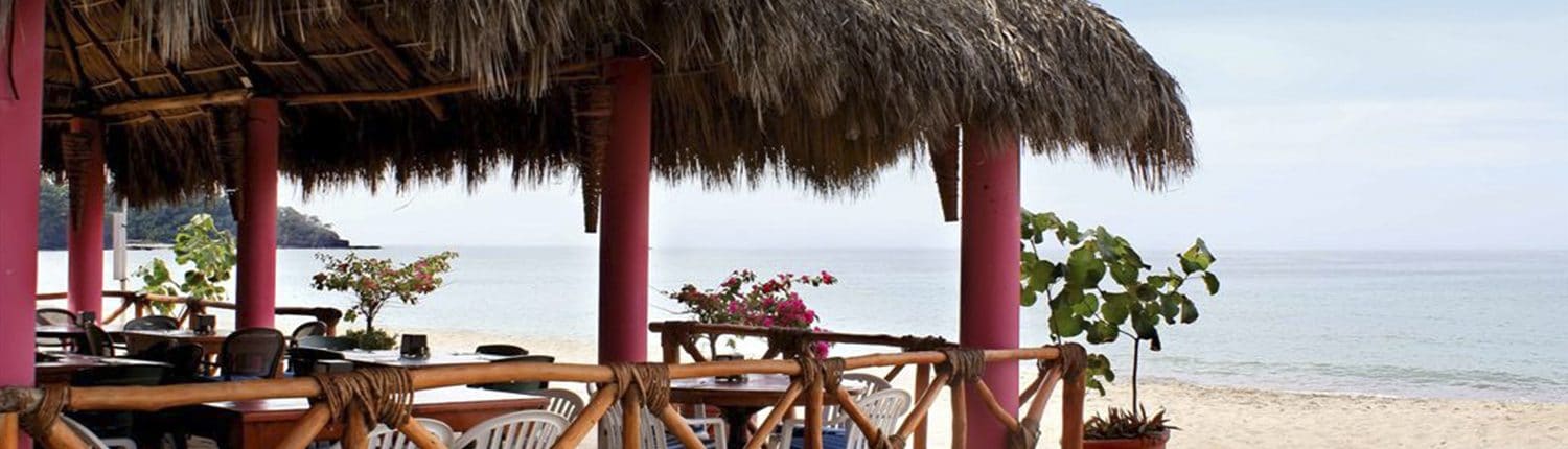 Palapa covered beach restaurant at Decameron Los Cocos hotel in Guayabitos Riviera Nayarit Mexico