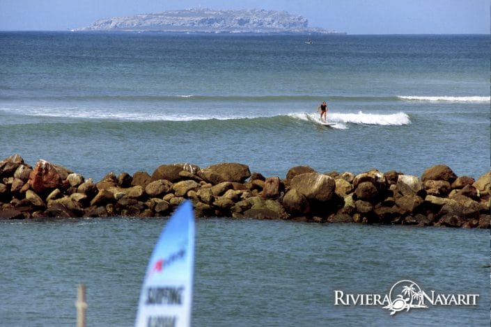 Surfer riding the wave in Riviera Nayarit Mexico