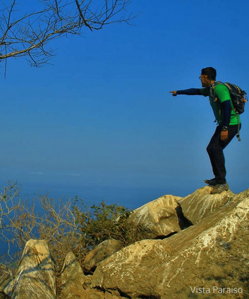 Man pointing out to sea while hiking on the Pacific Coast of Nayarit Mexico